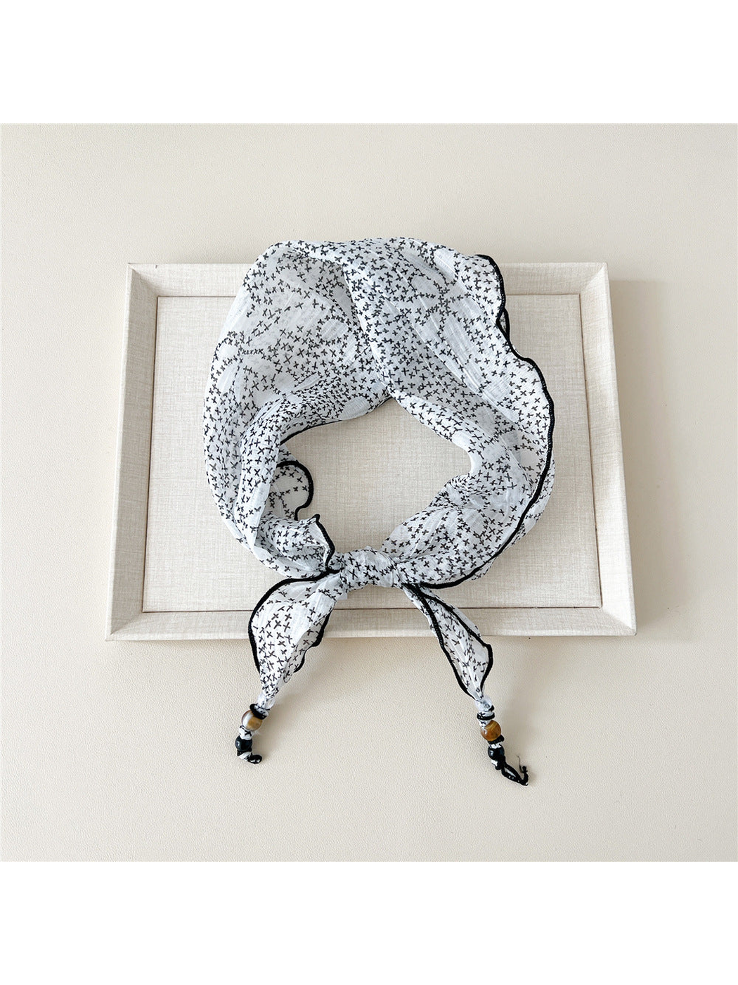White Cross triangular scarf tied with beaded tips