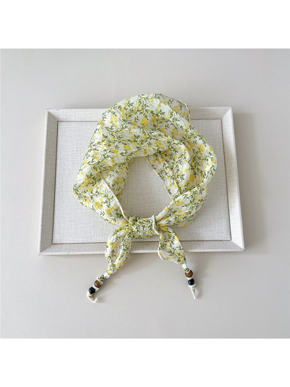Yellow Floral triangular scarf tied with beaded tips