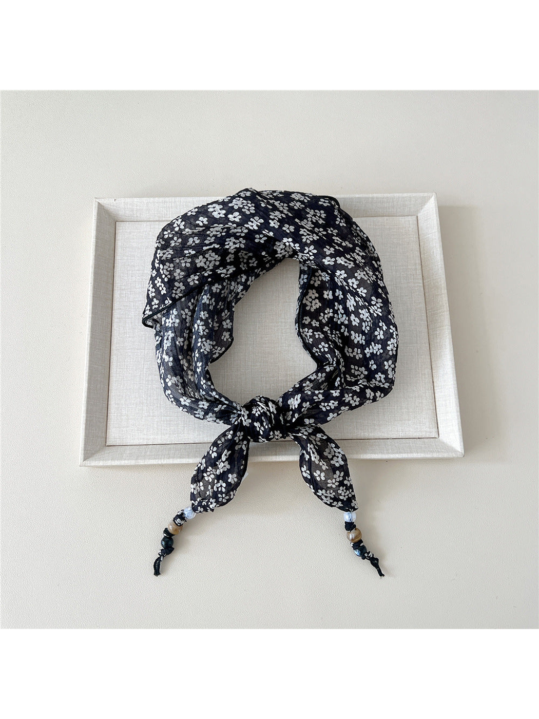 Black Petals triangular scarf tied with beaded tips