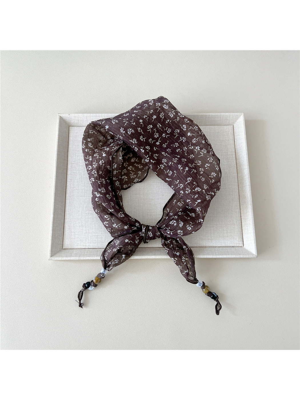Brown Sprigs triangular scarf tied with beaded tips