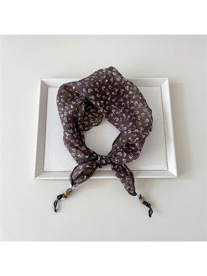 Brown Sprigs triangular scarf tied with beaded tips