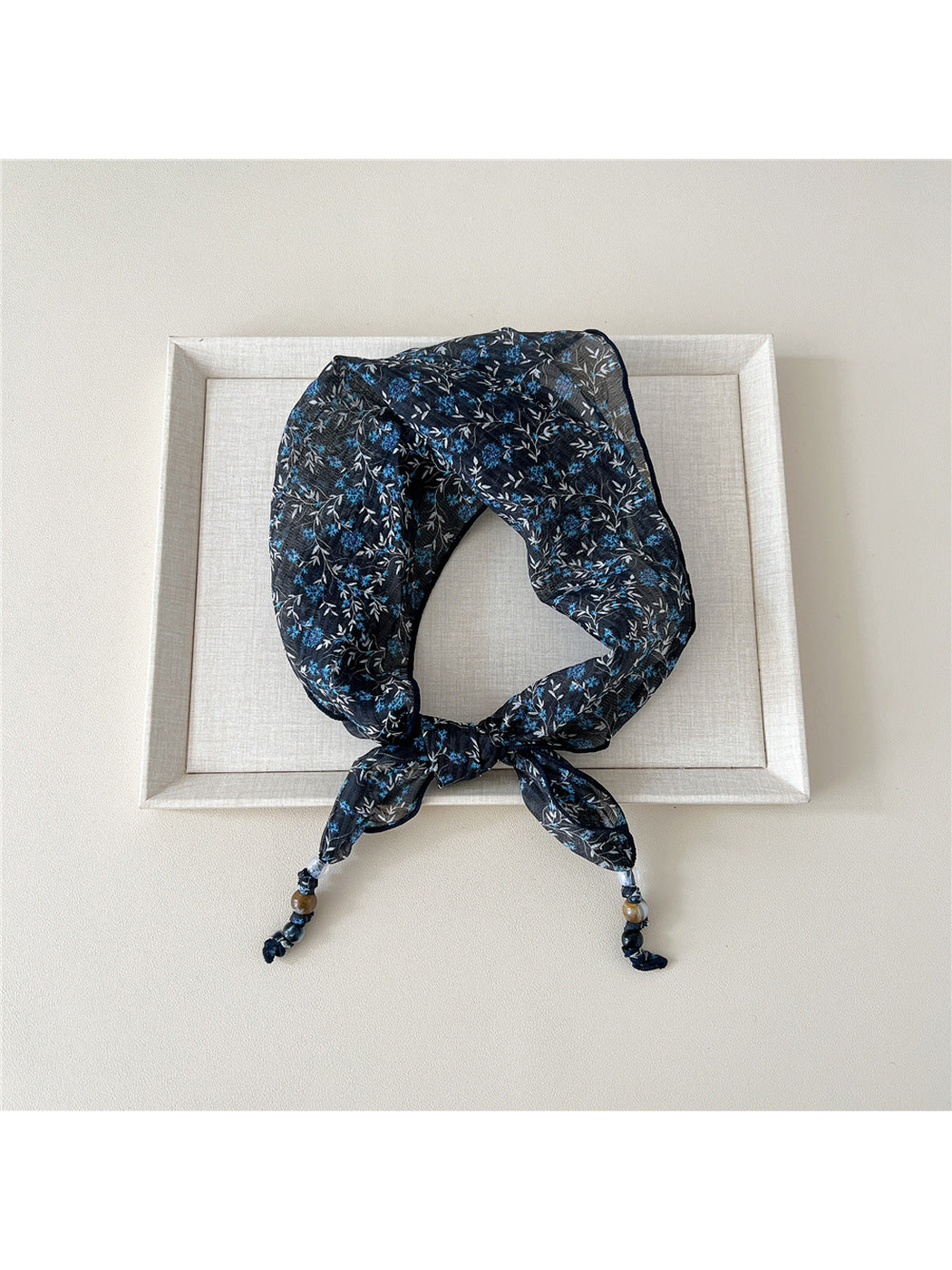 Navy Blossoms triangular scarf tied with beaded tips