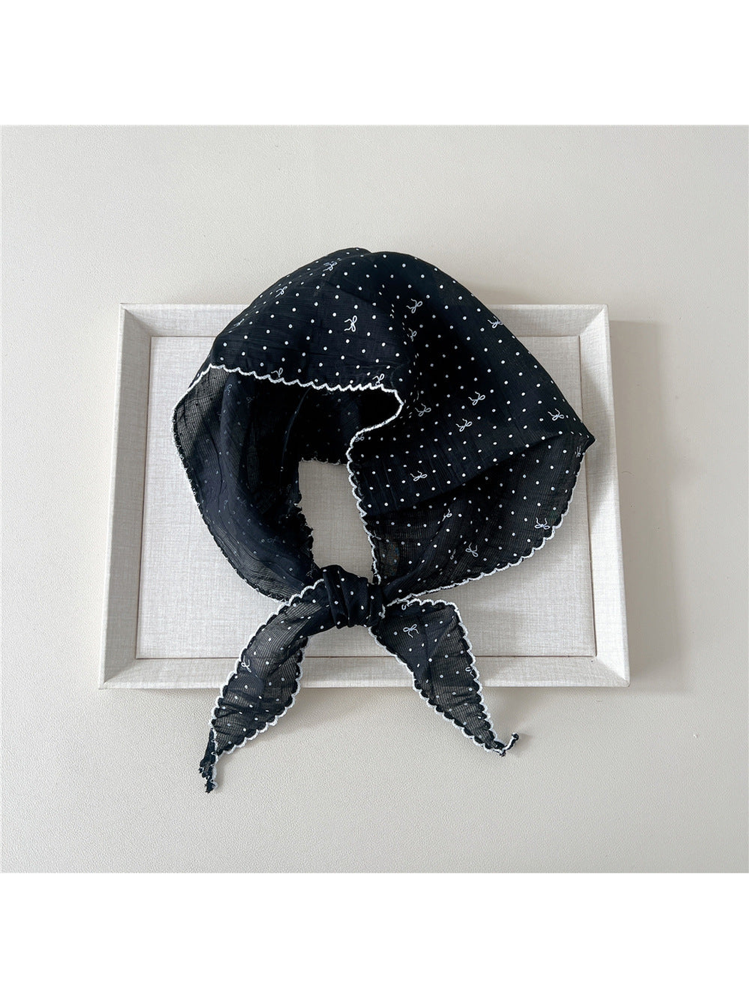 Black triangle scarf with polka dots, bow motifs and scalloped edging
