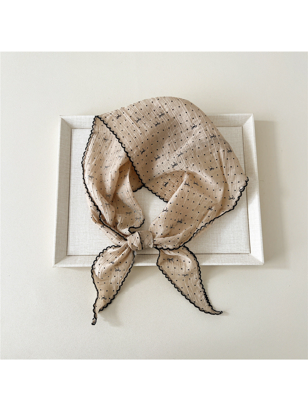 Beige triangle scarf with polka dots, bow motifs and scalloped edging