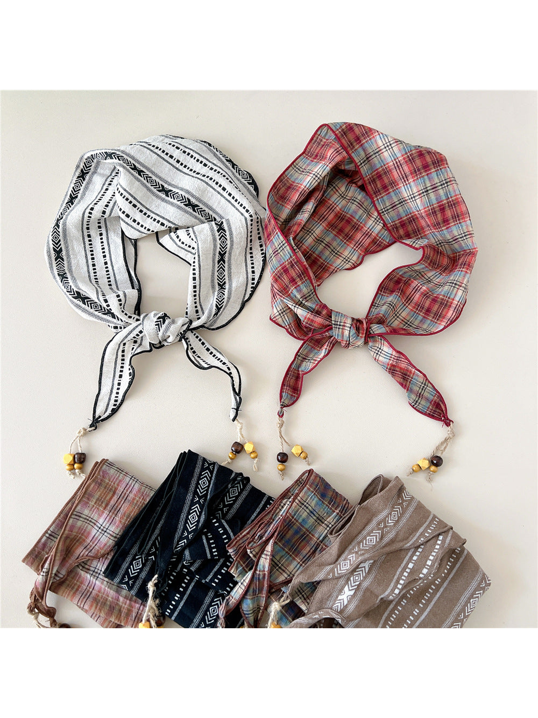 Multiple scarf styles arranged in tied and folded views