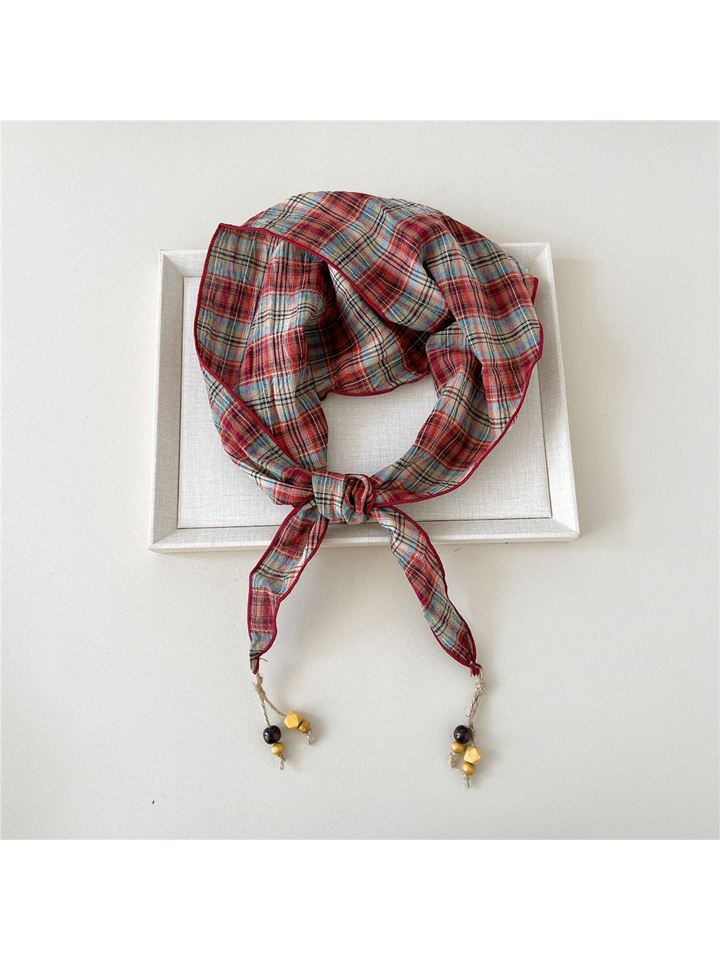 Red plaid triangle scarf with bead-tipped ends