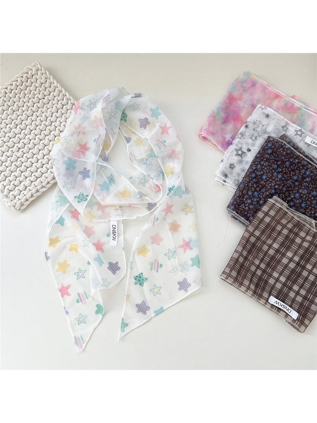 Multicolor Stars scarf draped beside folded patterned scarf styles