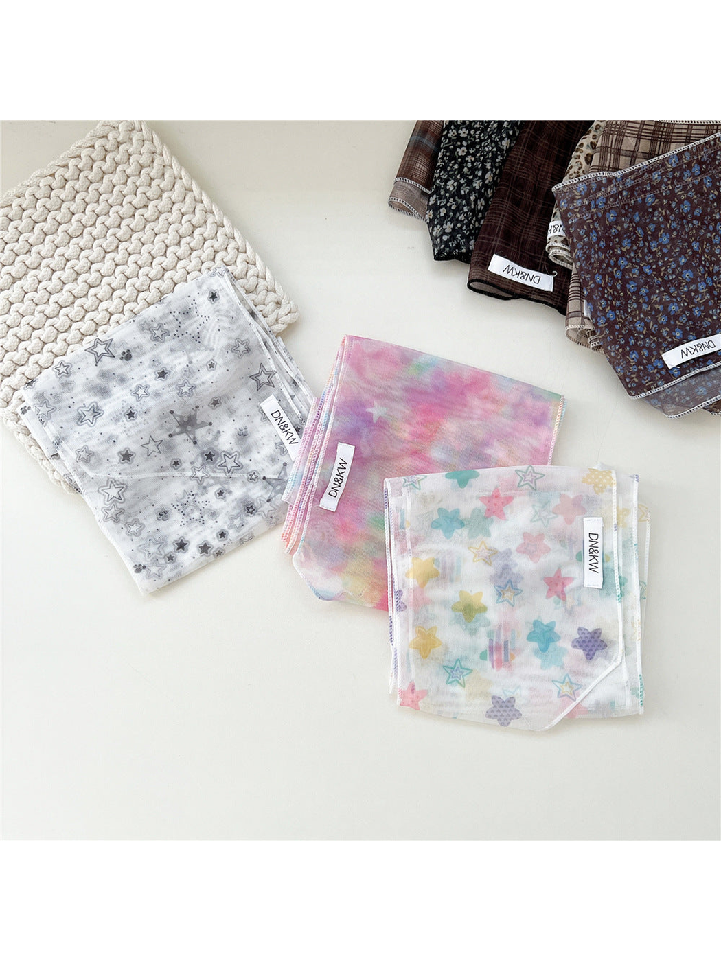 Star and floral long narrow scarf styles displayed folded together