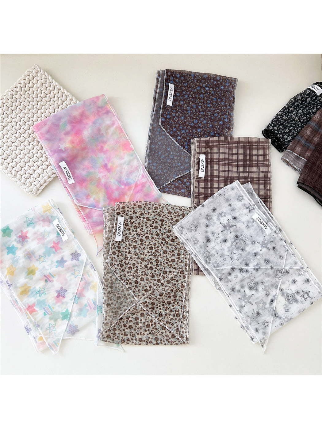Multiple star, floral and plaid long narrow scarf styles displayed together