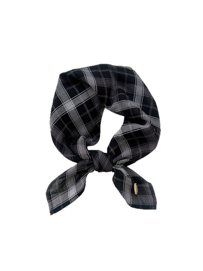 Black and gray plaid scarf tied on a white background