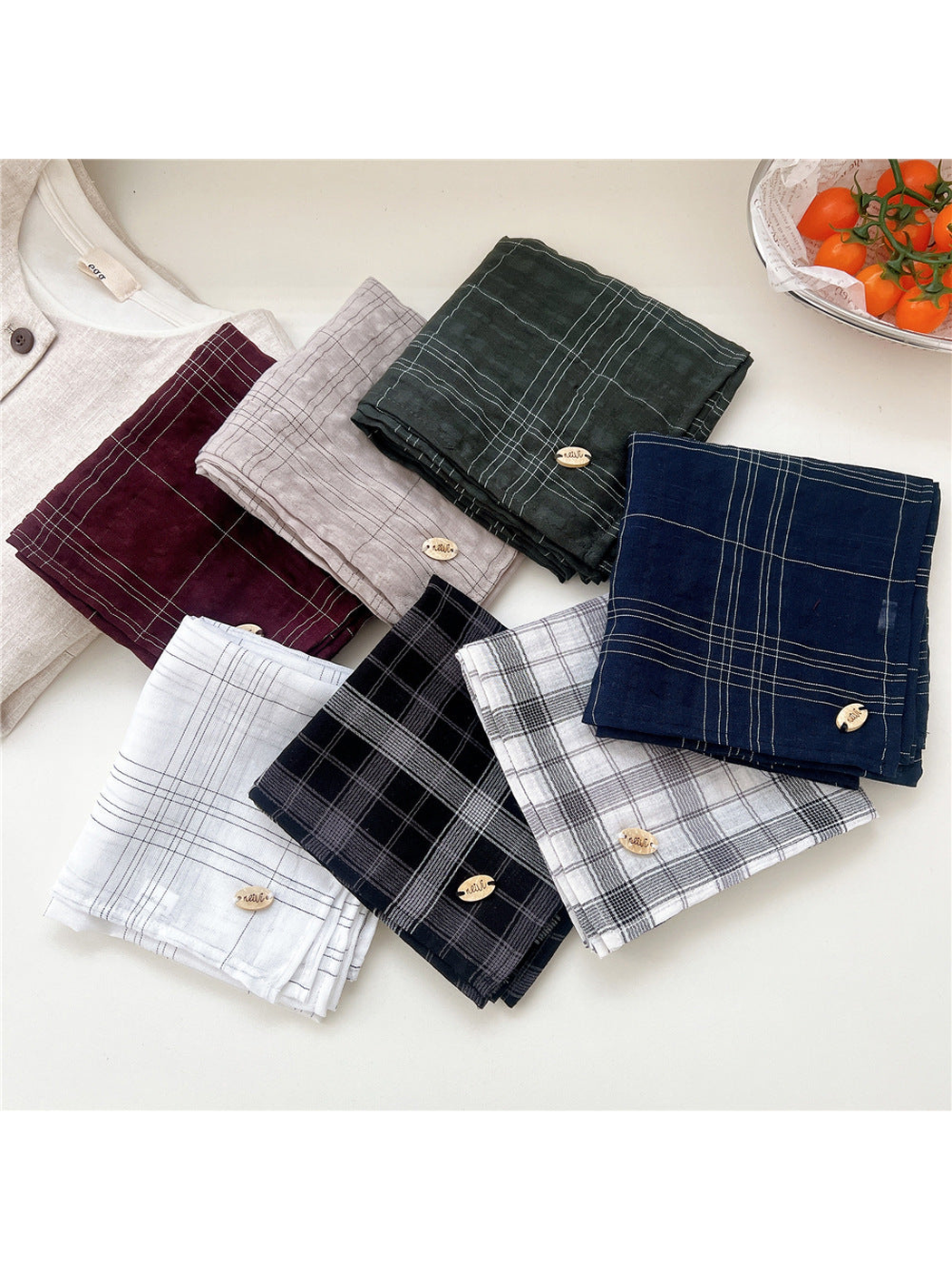 Assorted plaid scarves displayed folded together