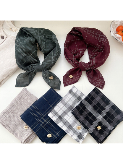 Plaid scarves displayed tied and folded in assorted colors