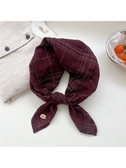 Burgundy fine-line plaid scarf tied in a loop