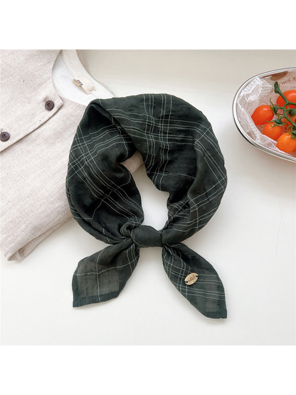Dark green fine-line plaid scarf tied in a loop