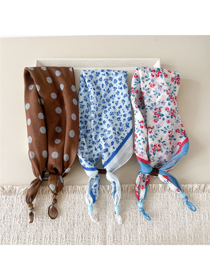 Three scarf-style headbands with brown, blue floral, and red blossom patterns