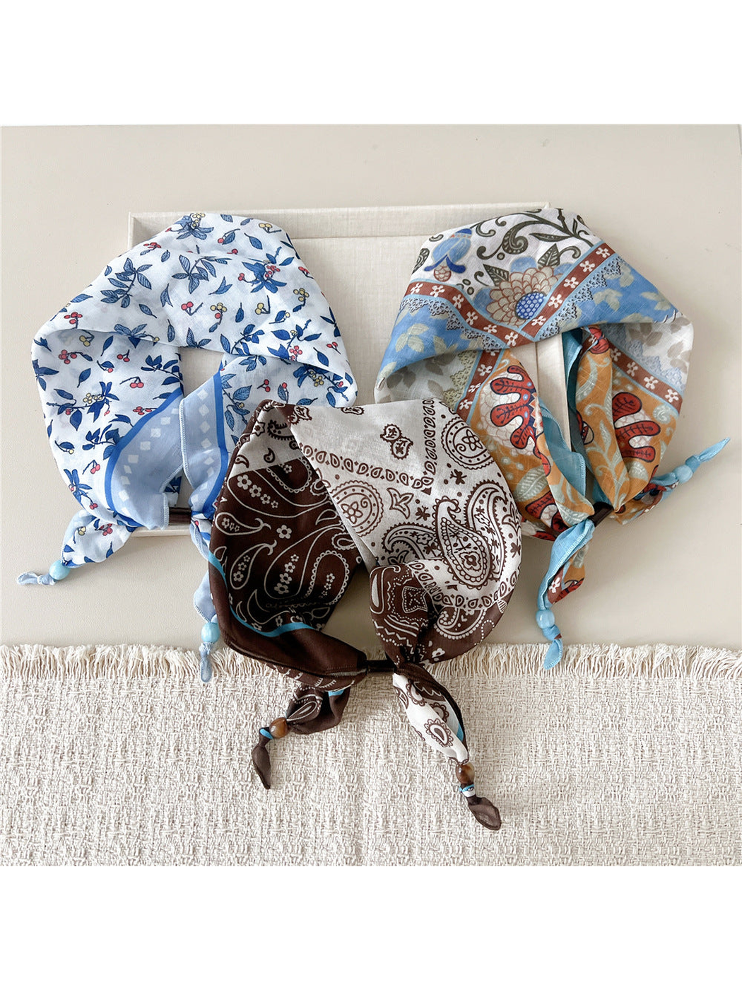 Three scarf-style headbands with berry branch, floral patchwork, and paisley patterns