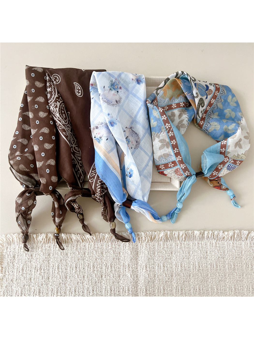 Four scarf-style headbands in coordinating brown and light blue patterns