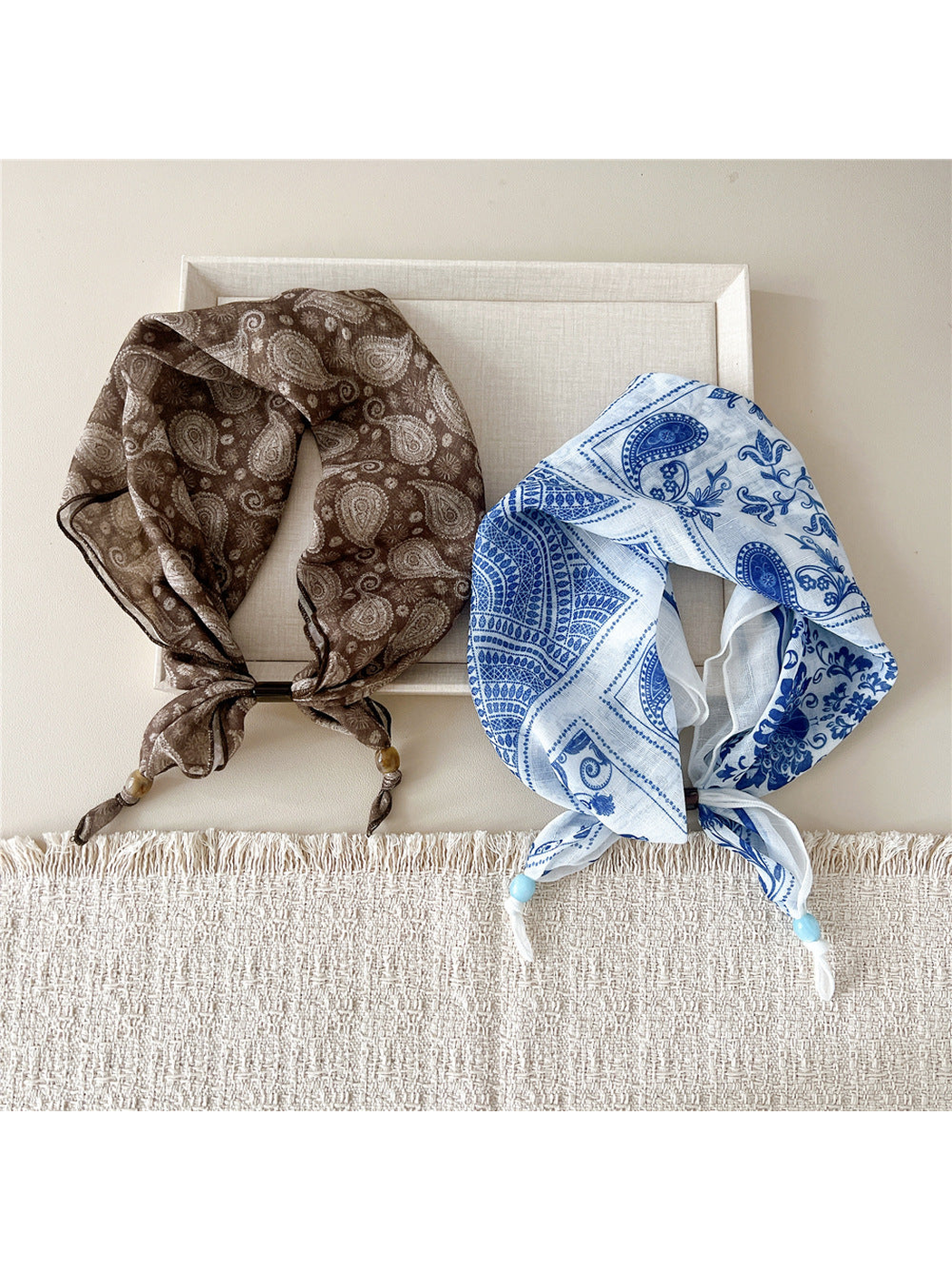 Brown paisley and blue peacock floral scarf-style headbands displayed together