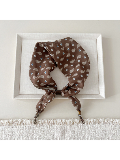 Blue Flowers scarf-style headband on a brown background with beaded tie ends