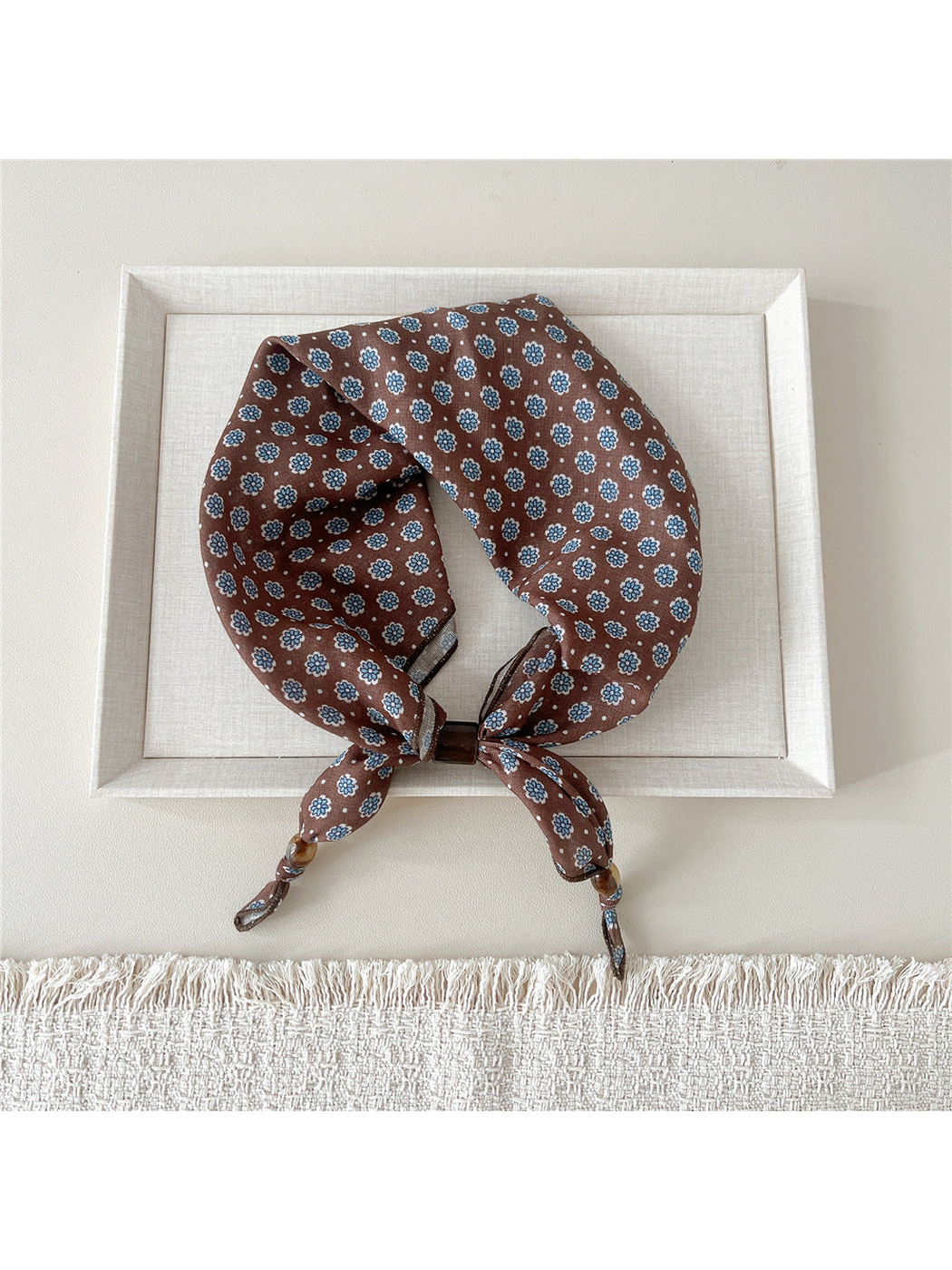 Eight Petal scarf-style headband with repeating blue flowers on brown