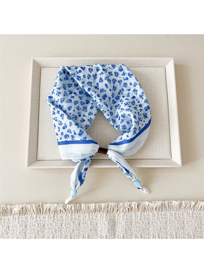 Scattered Floral scarf-style headband with small blue flowers and a blue border