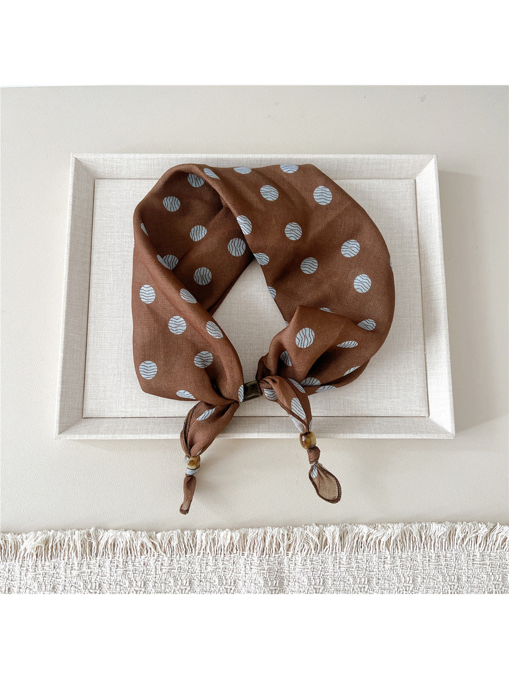 Wavy Circles scarf-style headband with pale blue circles on brown