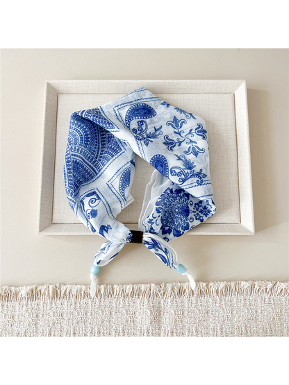 Peacock Floral scarf-style headband in blue and white with patchwork motifs
