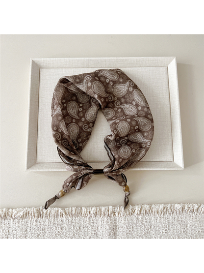 Radiating Floral scarf-style headband with cream paisley motifs on brown
