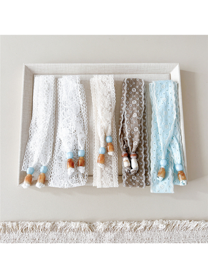 White, ivory, brown and light blue skinny scarf styles displayed together