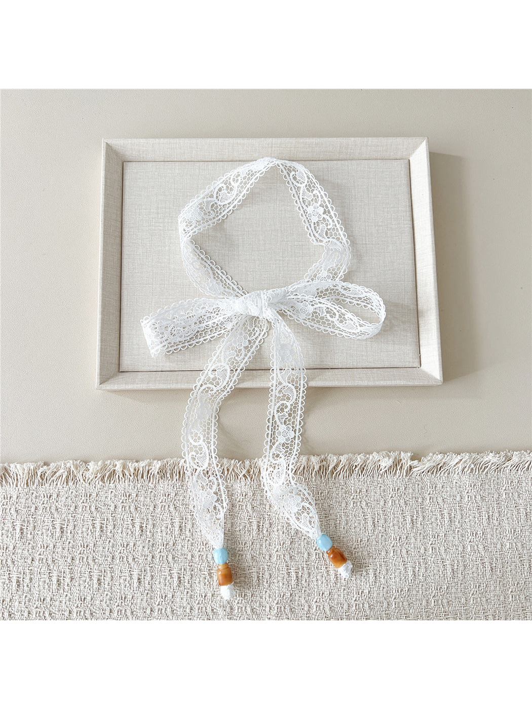 White Looped Floral skinny scarf tied in a bow with beaded ends