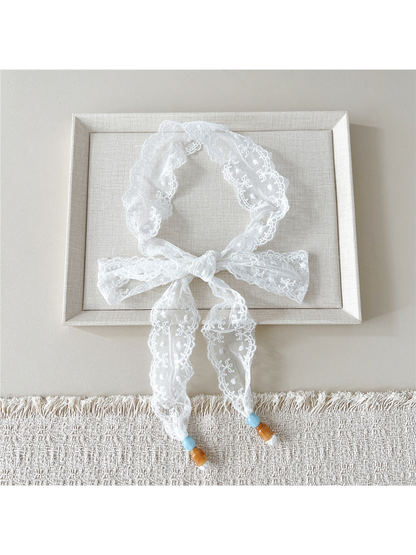 White Dotted Floral skinny scarf tied in a bow with beaded ends
