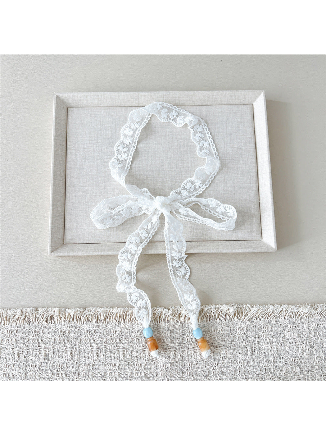 White Daisy skinny scarf tied in a bow with beaded ends