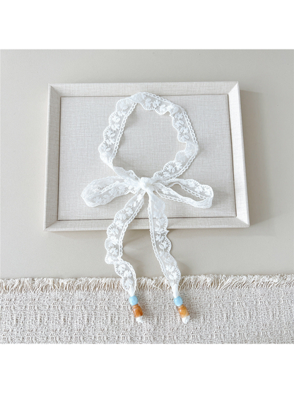 White Daisy skinny scarf tied in a bow with beaded ends