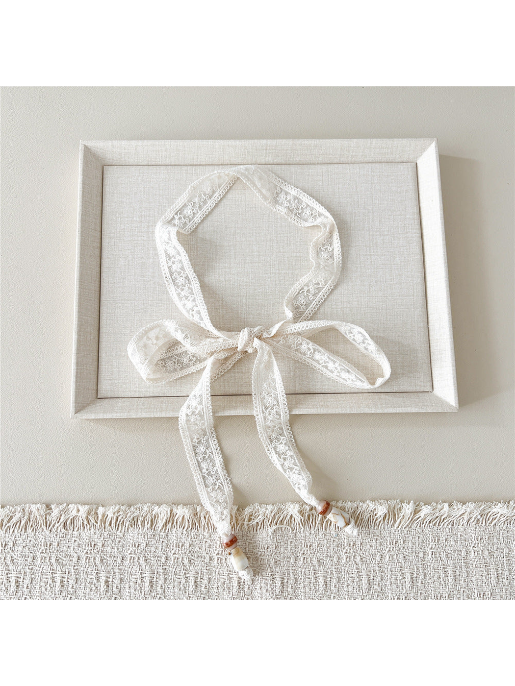 Ivory Floral Sprig skinny scarf tied in a bow with beaded ends