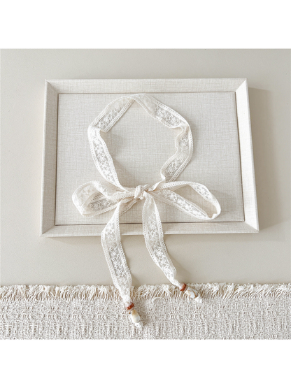 Ivory Floral Sprig skinny scarf tied in a bow with beaded ends