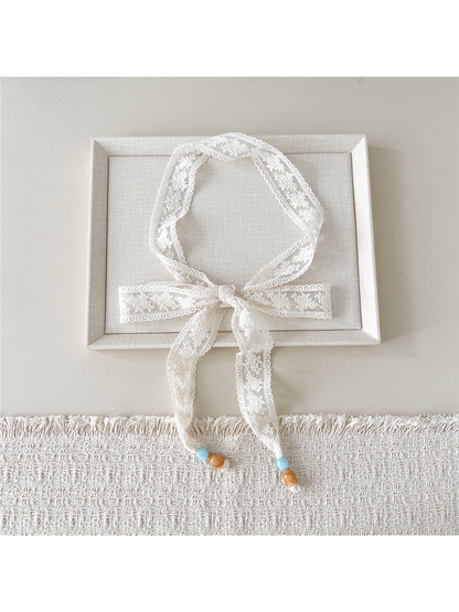 Ivory Floral Vine skinny scarf tied in a bow with beaded ends