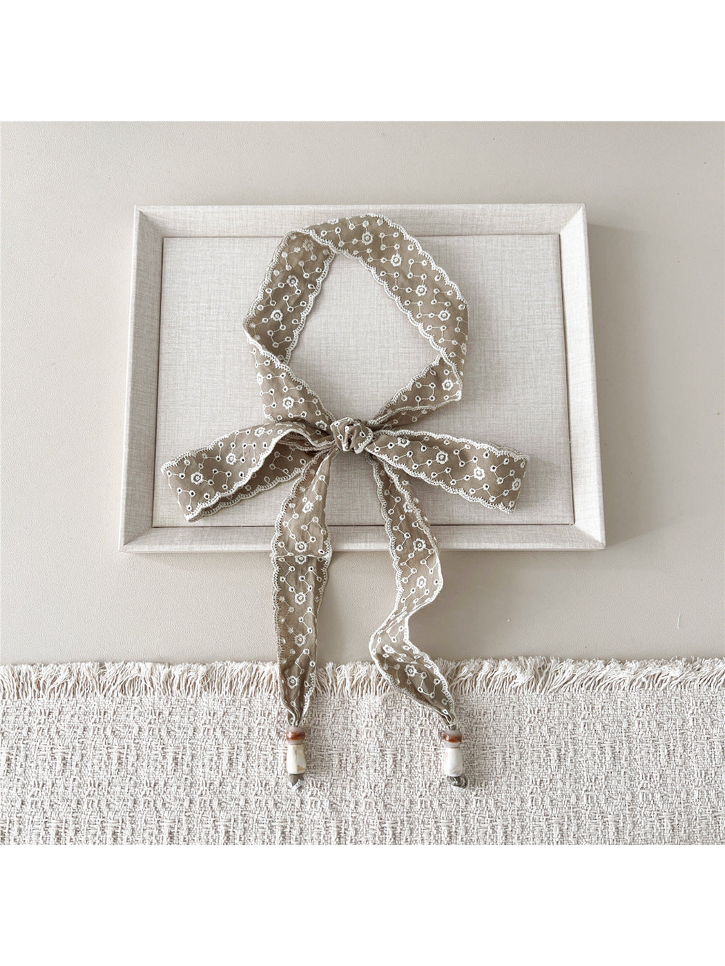 Brown Flower Lattice skinny scarf tied in a bow with beaded ends