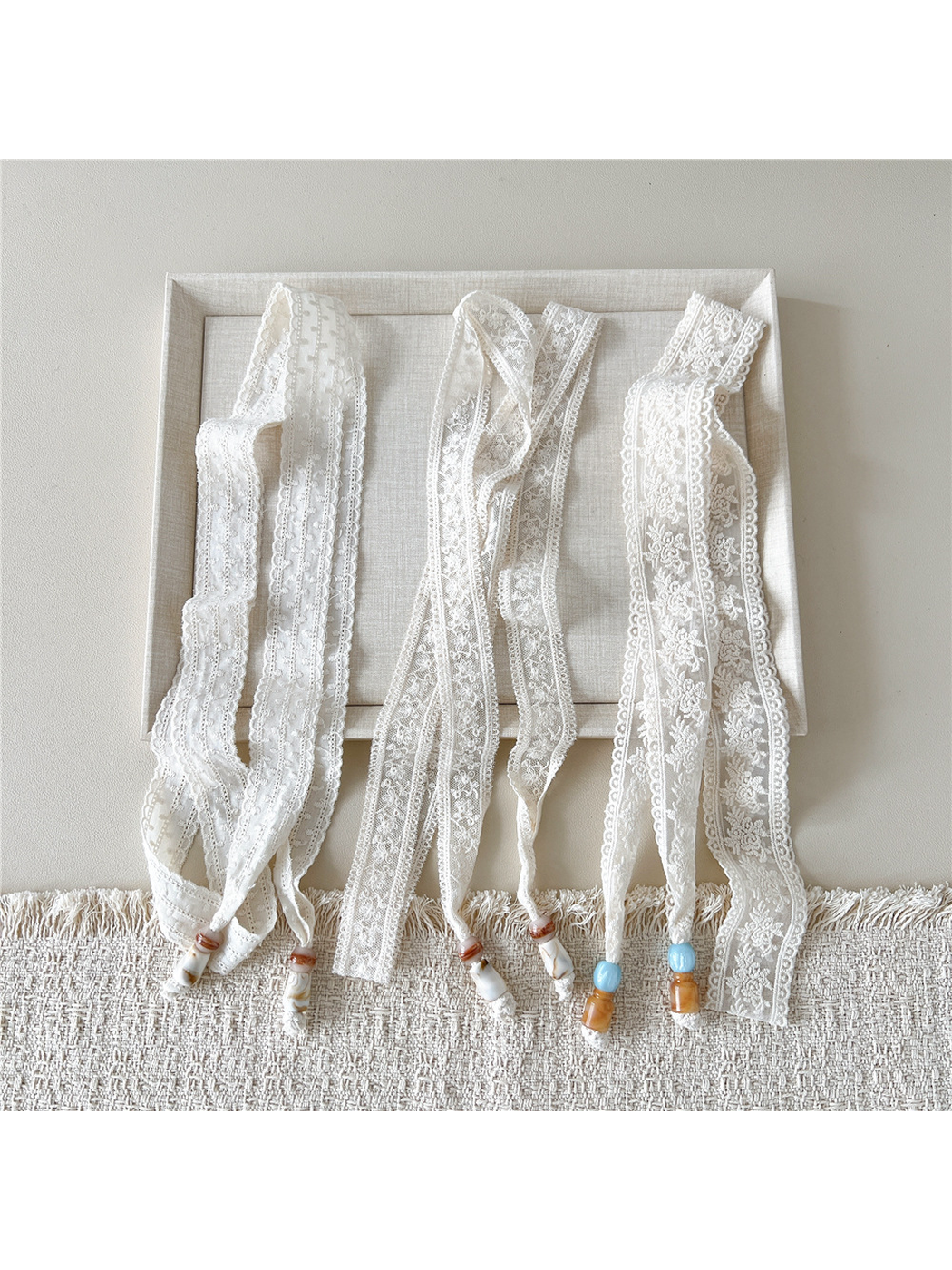 Three ivory embroidered skinny scarf styles displayed untied