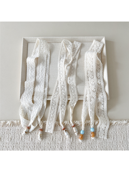 Three ivory embroidered skinny scarf styles displayed untied