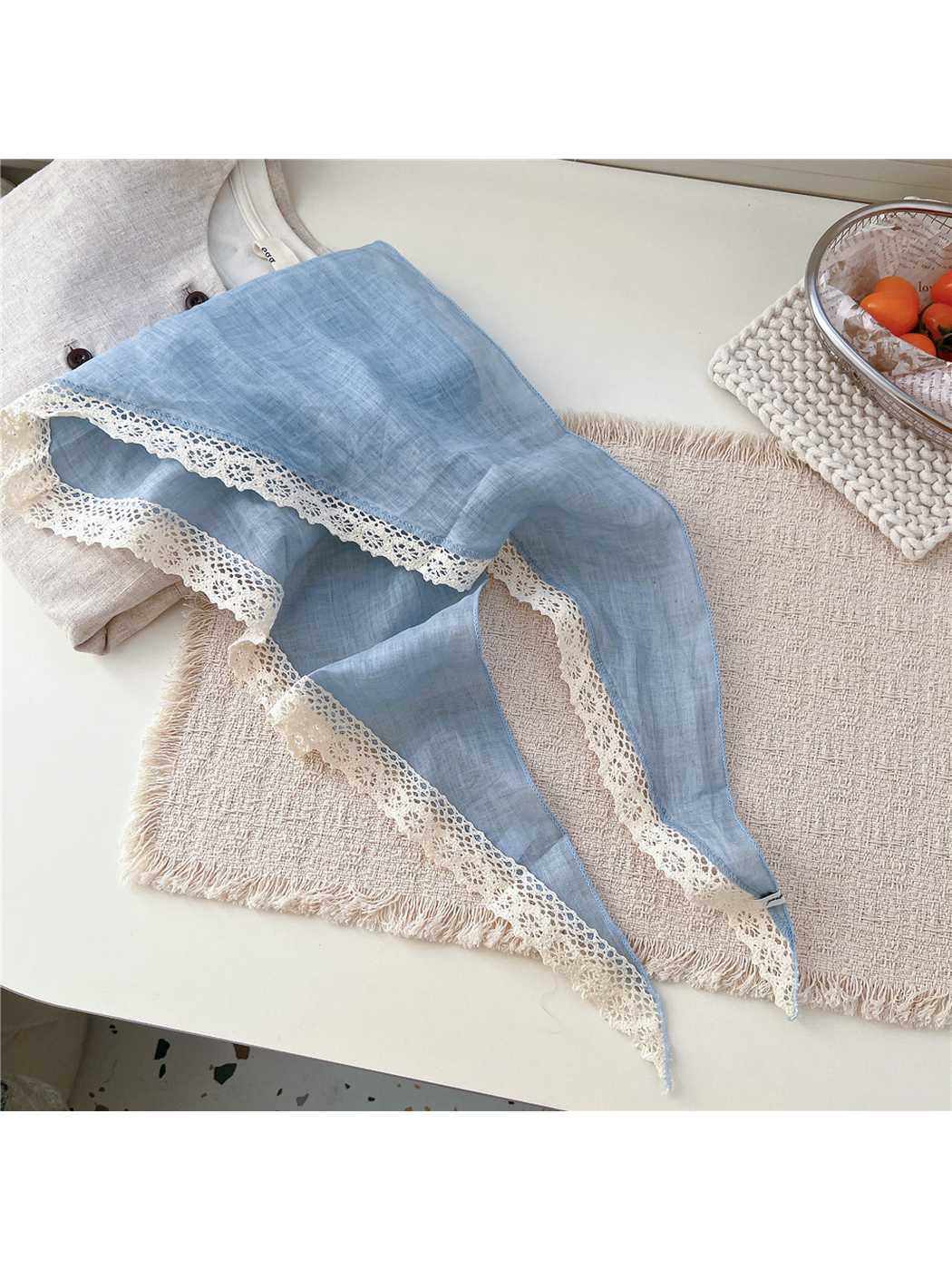 Light Blue triangle scarf laid open with cream openwork lace trim