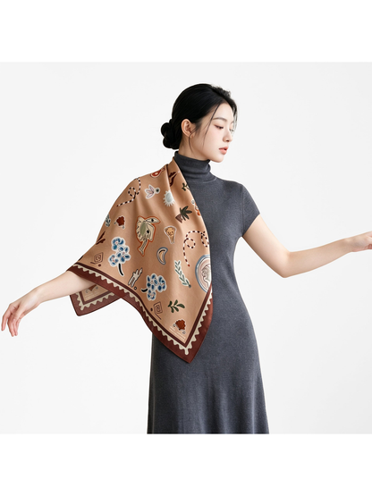 Model wearing the brown patterned square scarf draped over one shoulder