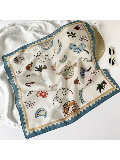 Ivory abstract-print square scarf spread across a light fabric setting