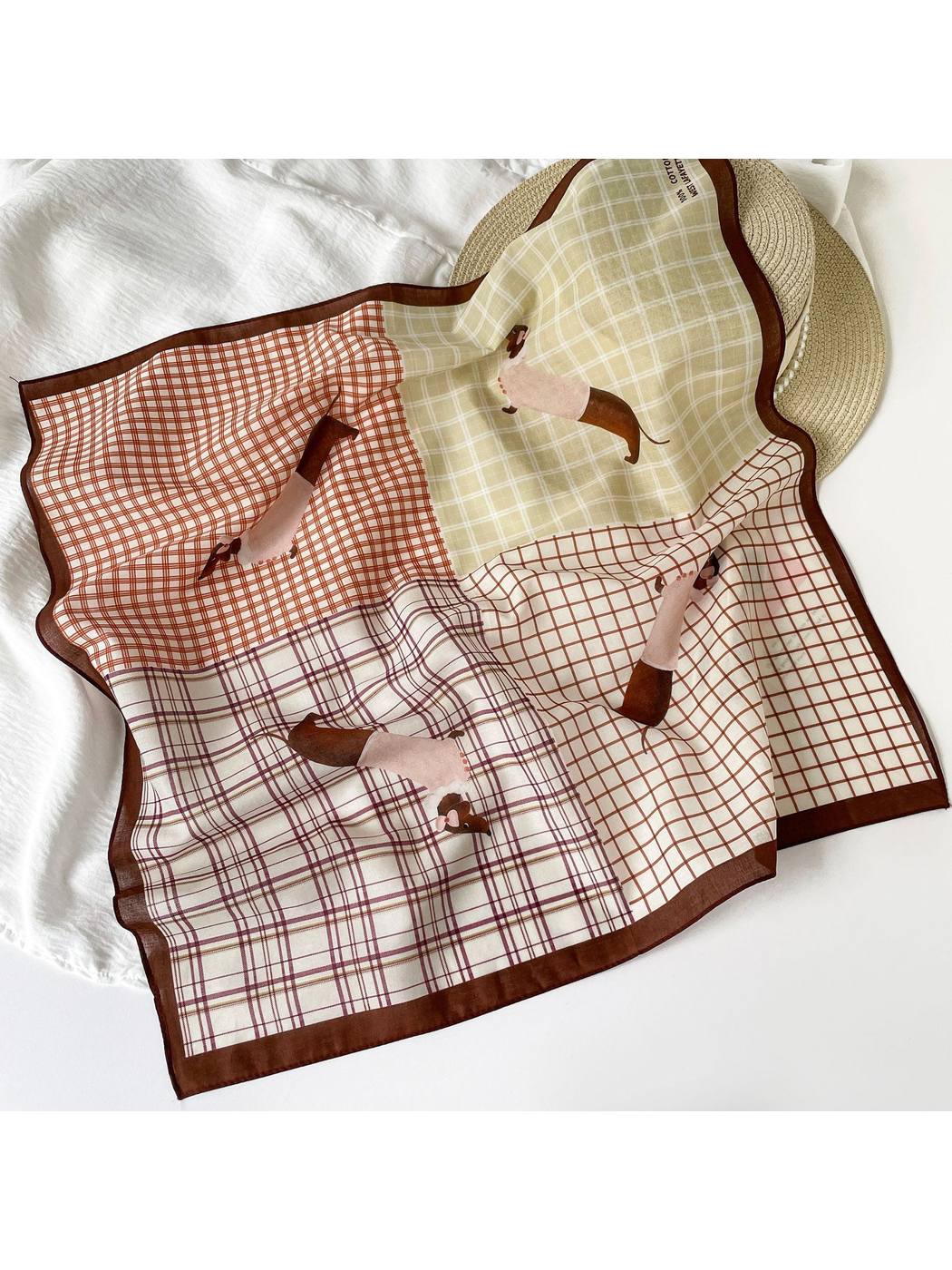 Patchwork plaid square scarf draped flat with dachshund motifs