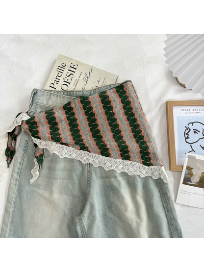 Dark Green patterned scarf styled around the waist of gray jeans