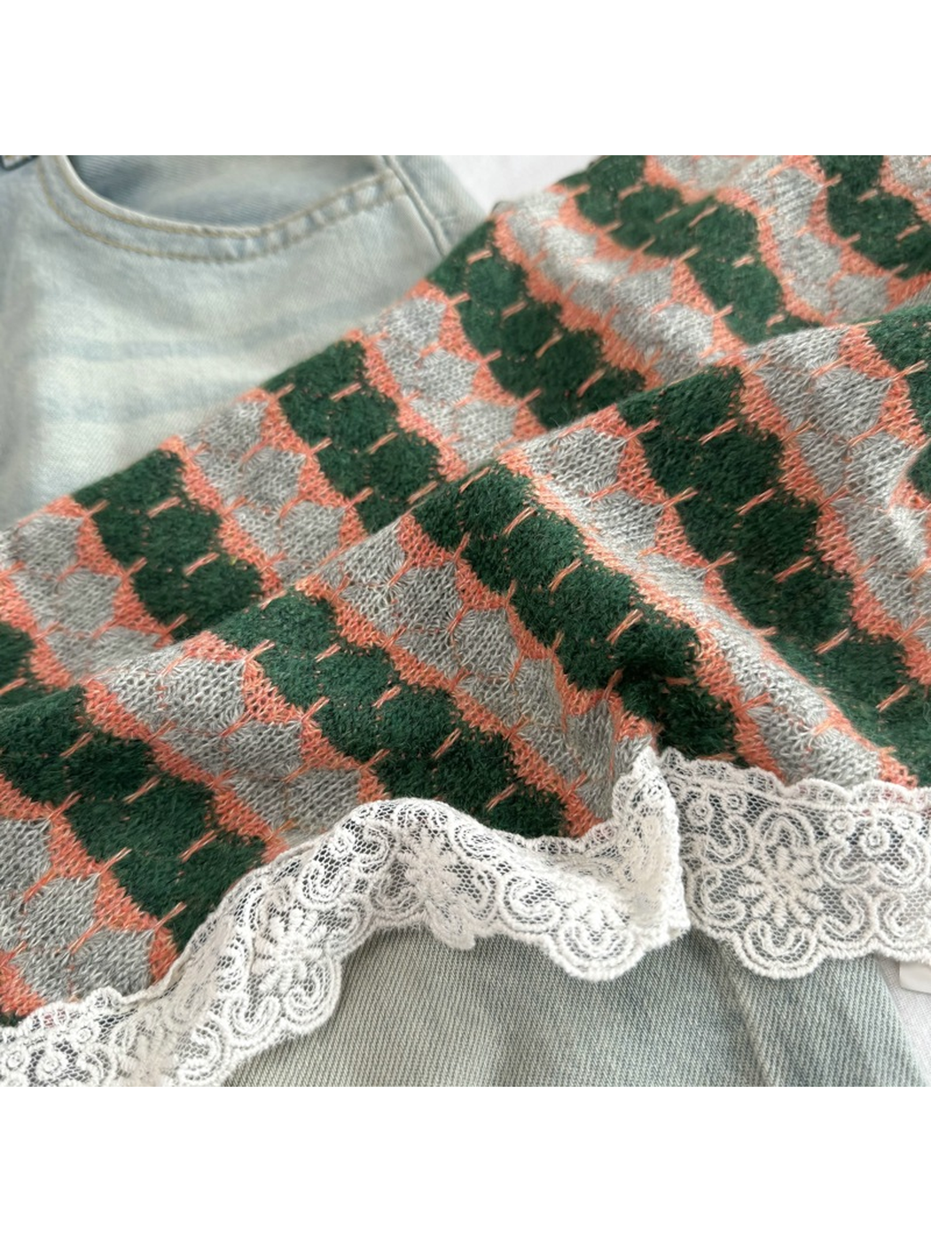 Close-up of the Dark Green geometric pattern and ivory scalloped lace edging