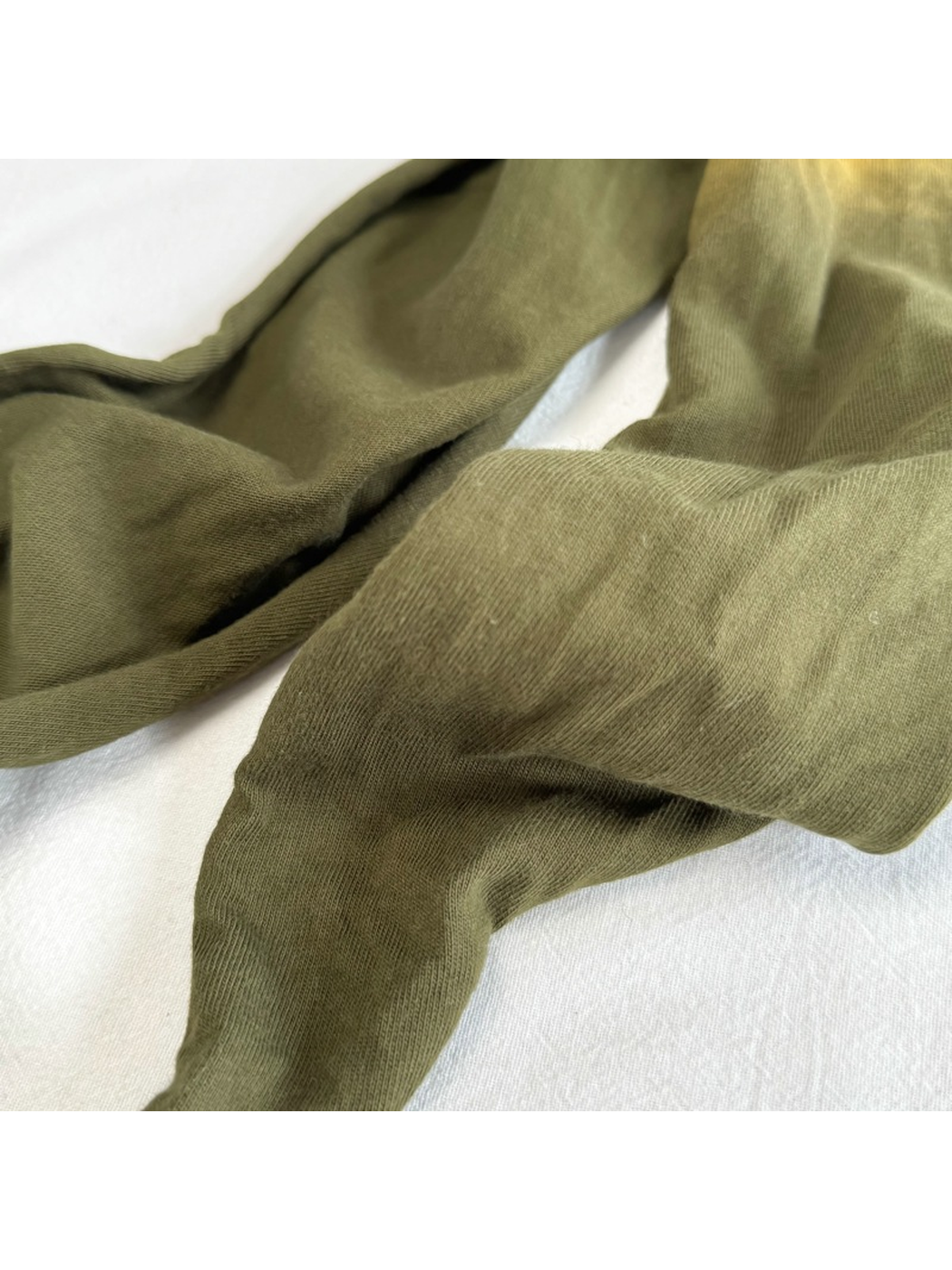 Close-up of the Army Green scarf's fine ribbed surface texture