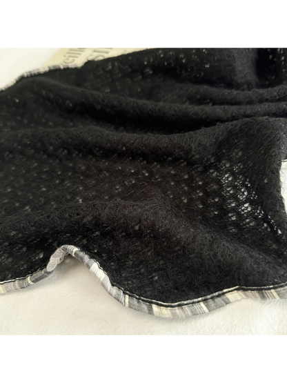 Close-up of Black openwork texture and plaid edge trim