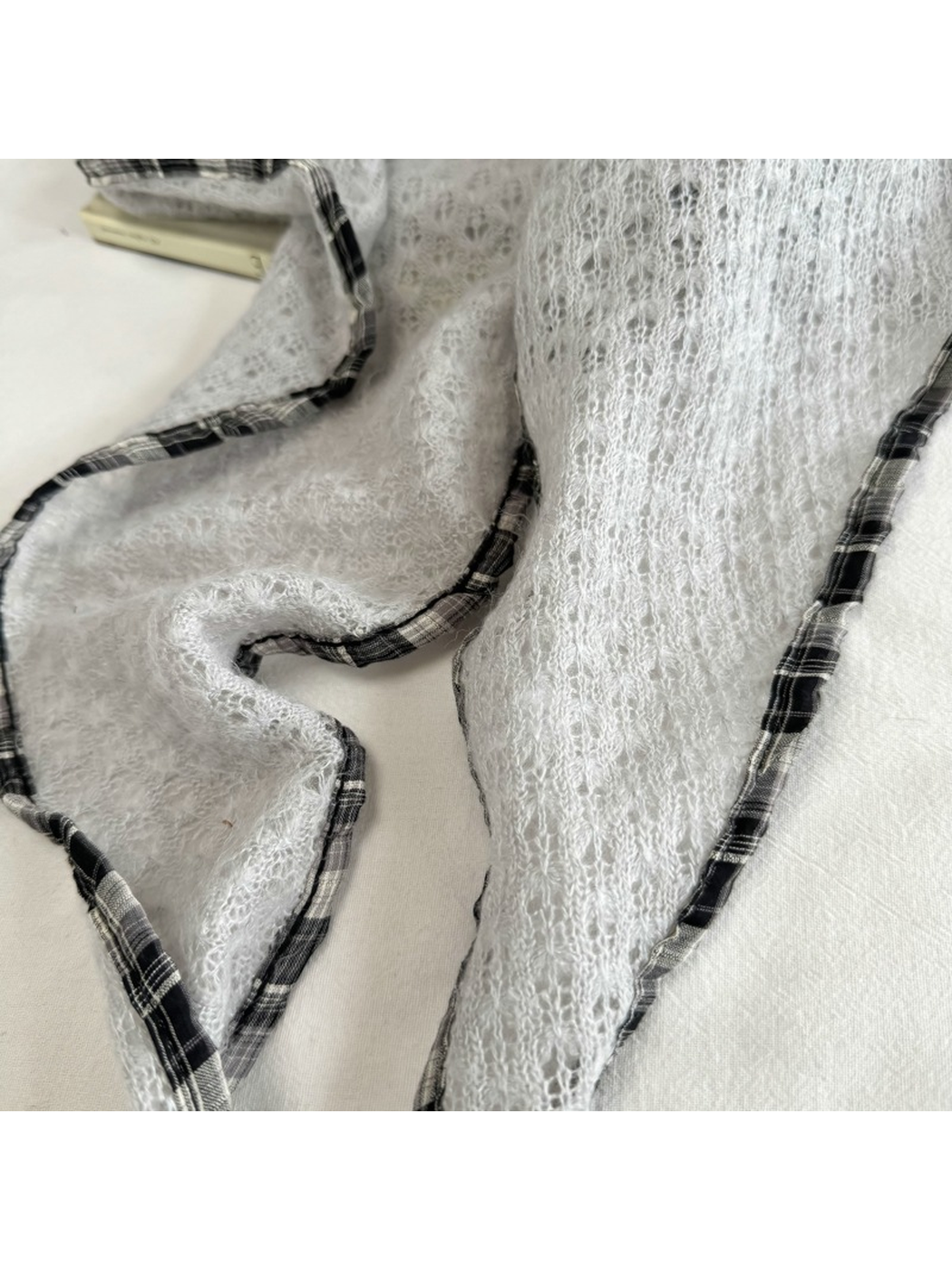 Close-up of Light Gray openwork texture and plaid edge trim