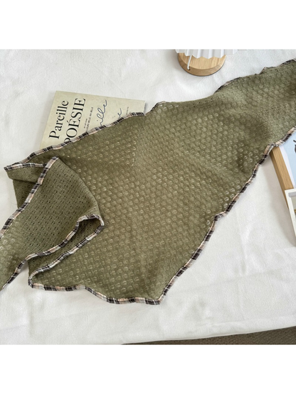 Army Green openwork scarf laid flat to show its tapered shape and plaid edge trim