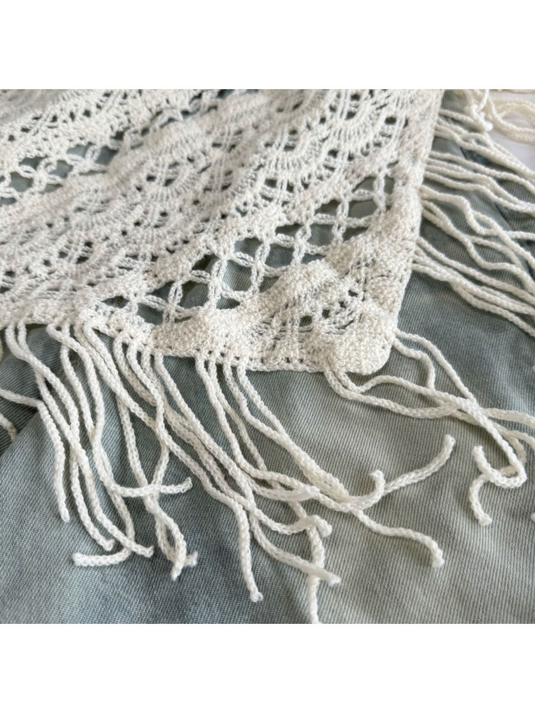 Close-up of the Ivory openwork edge and long fringe